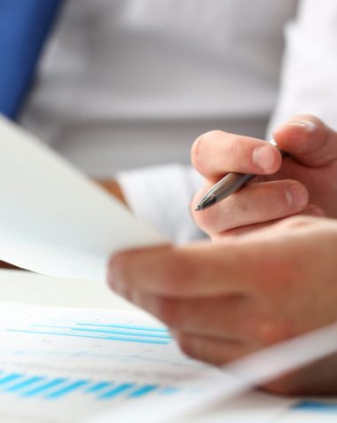 Group of businessmen with financial graph and silver pen in arm solve and discuss problem with colleague closeup. Situation examination at board council sale adviser job stock exchange market profit